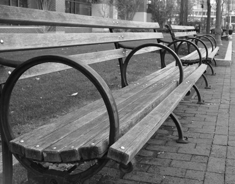 Black and white shot of park benches.