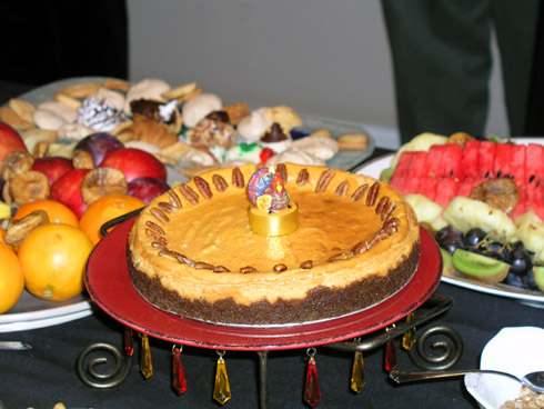 Turkey-shaped candle on a pumpkin pie.