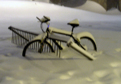 Bike buried in the snow.