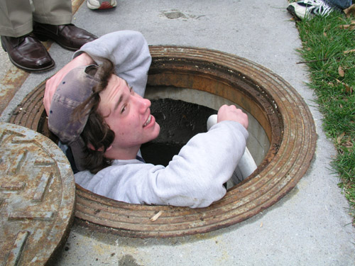 Danny rescuing a disc from the sewer.
