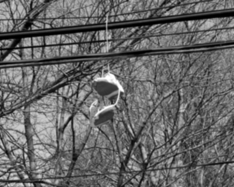 Shoes hanging from a power line.