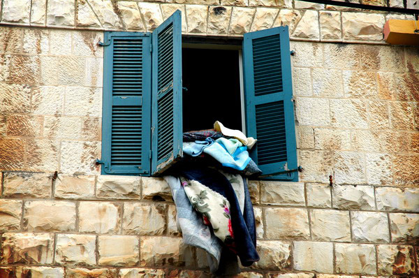 Clothes dangling from a window.